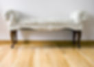 A old-fashioned bench with white upholstery