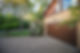 Trees and flowering bush around home showcase exterior garage door and driveway