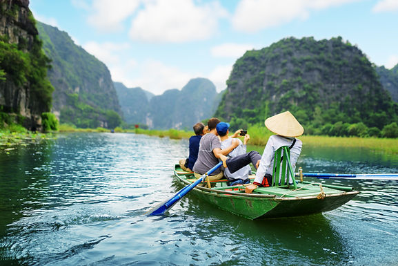 Tourists taking a selfie on a boat in Ngo Dong river, Ninh Binh, Vietnam