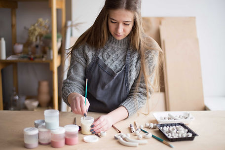 Jewelry artisan designing custom necklace in boutique workspace