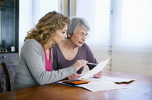 Young woman and an older woman looking at paperwork