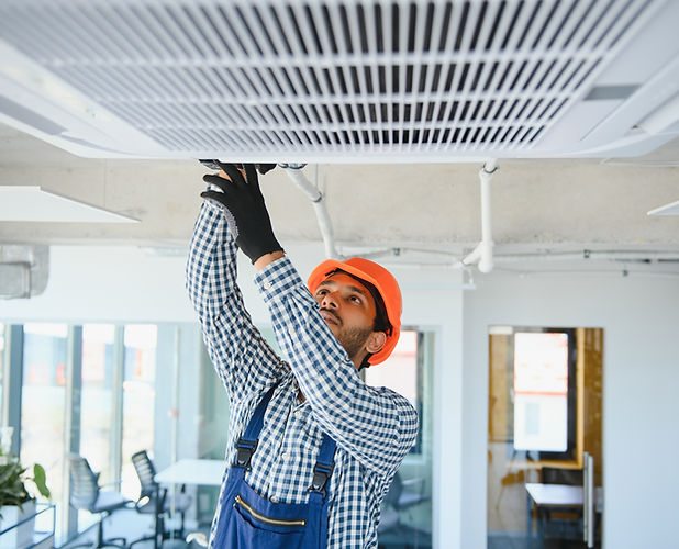 a-man-installing-HVAC-system-near-air-conditioner
