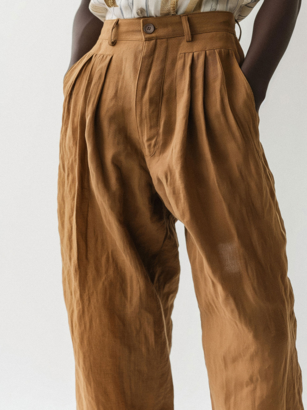 Woman wearing brown Cotton Pants with pleated front pockets, U&H eCommerce.