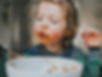 Child enjoying a plate of pasta