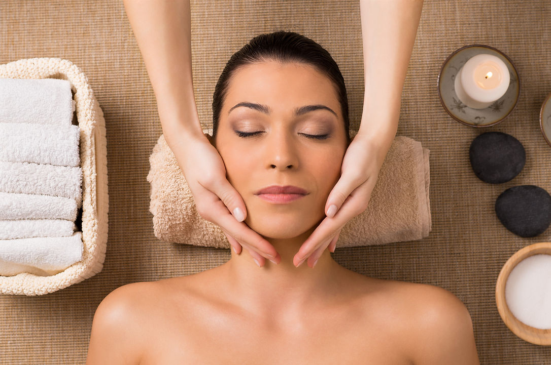 Beautiful Latin Woman Getting Facial Massage At Spa