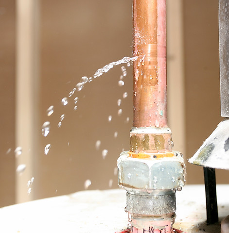 Water leaking out of a pipe on top of a water heater