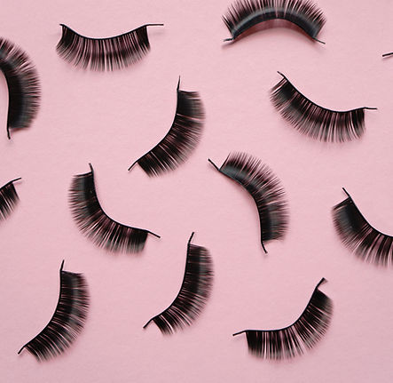 False eyelashes displaying on a pink background