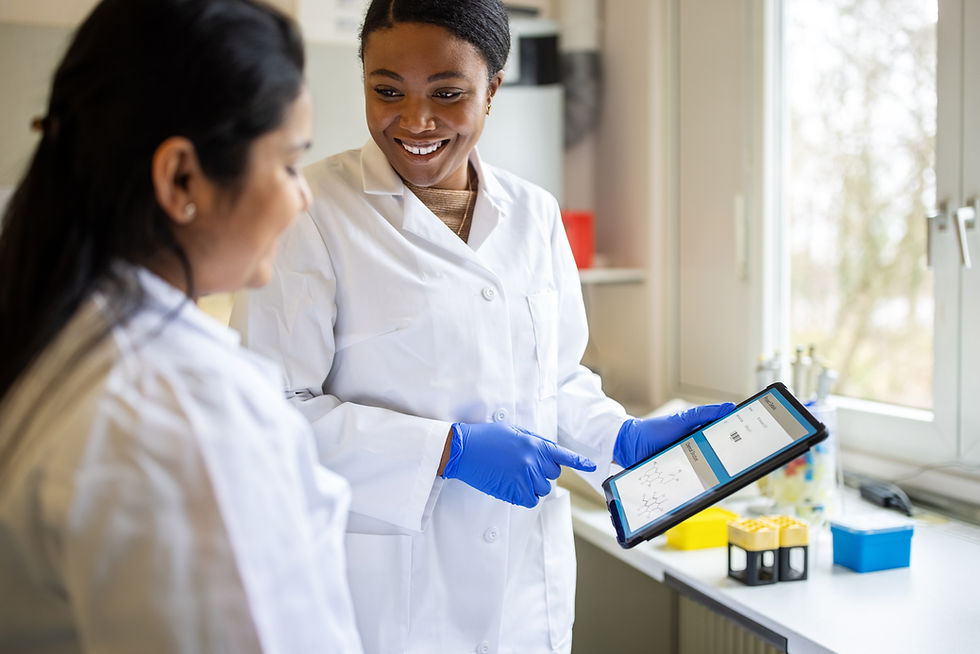 Two doctors talk with equipment with results in the hands of one of them. They appear to be in a laboratory and happy