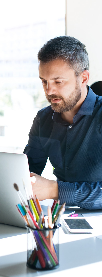 Business leader working on a laptop in a modern office