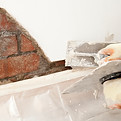 Repairing the plaster on a wall