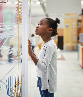 A Girl Looking at a Physics Model
