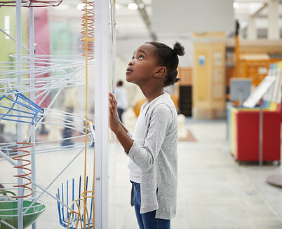 A Girl Looking at a Physics Model