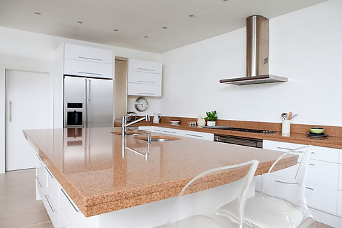 Modern kitchen featuring a large wooden island countertop and stainless steel extractor hood