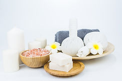 Spa products and flowers on white background