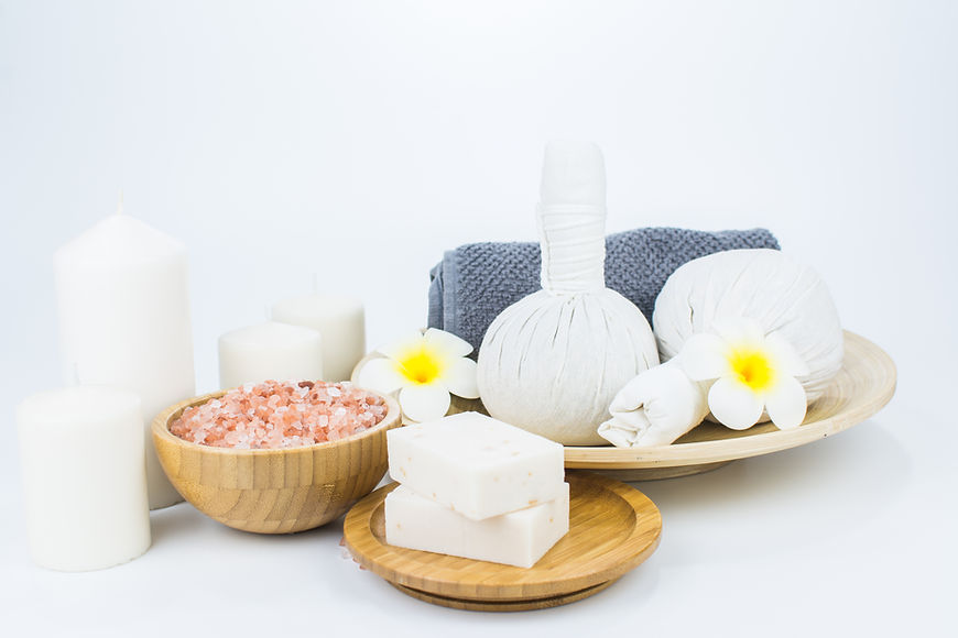 Spa products and flowers on white background