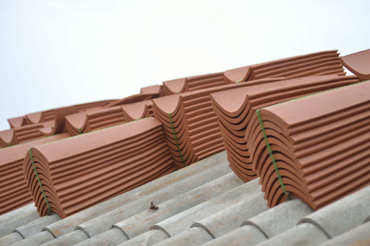 Close-up of a roof with red tiles stacked.