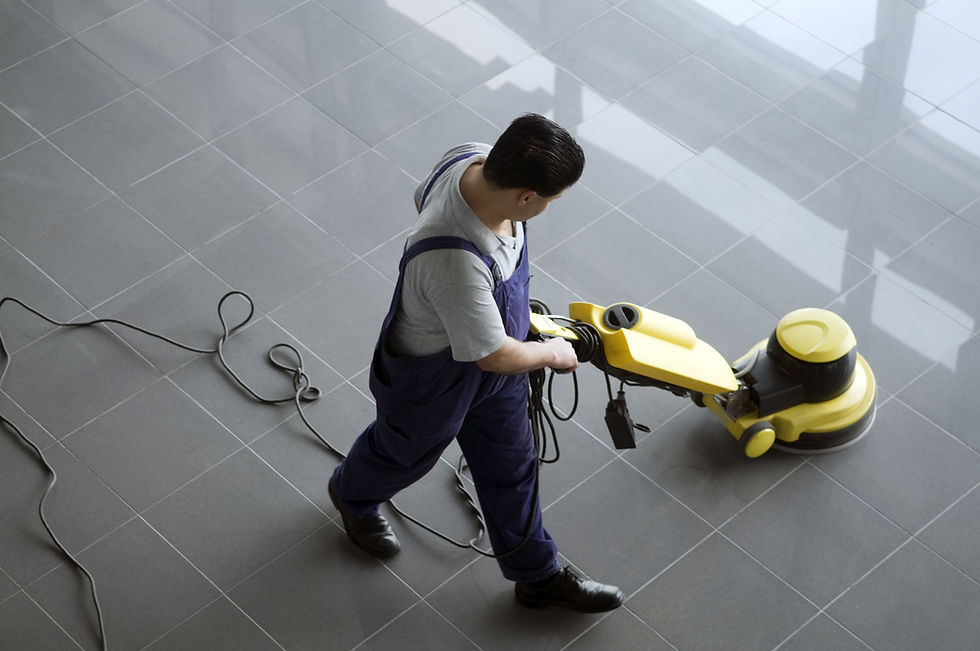 A professional cleaning a commercial floor