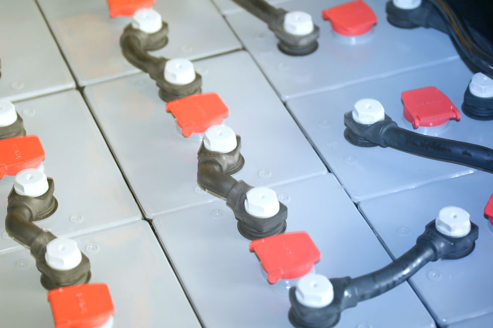 Close-up of interconnected battery terminals with red and white caps