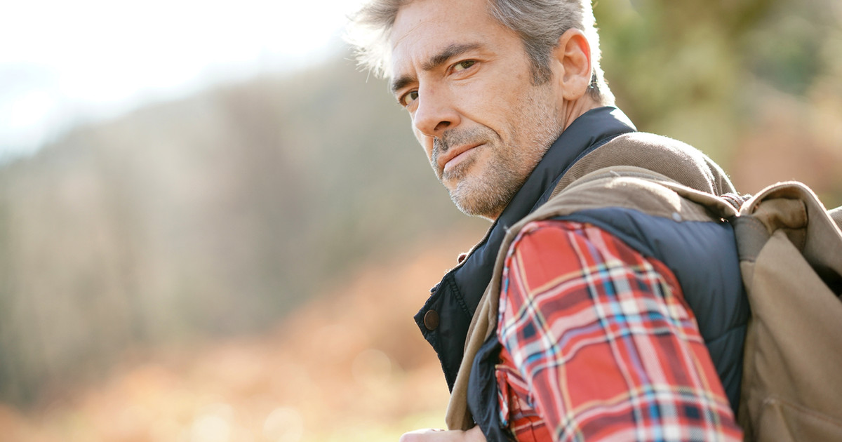 A person walking through a park at sunrise, reflecting on new possibilities and rebuilding a meaningful life while living with persistent pain.