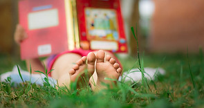 Child Reading in the Grass