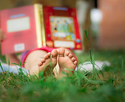 Child Reading in the Grass