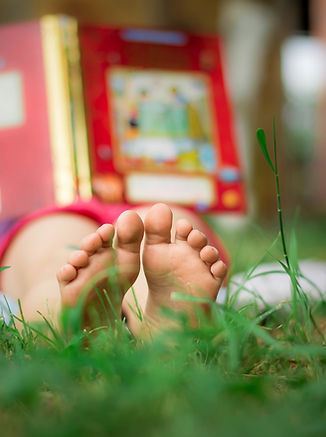 Child Reading in the Grass