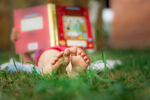 Child Reading Outdoors