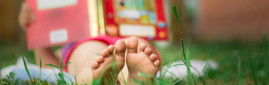 Child Reading in the Grass