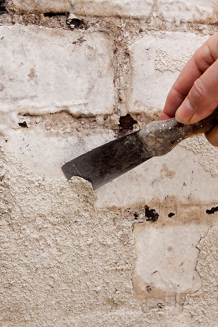 House Maintenance, scraping paint from a wall
