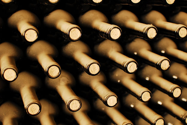 stacked up wine bottles in the cellar, dusty but tasty