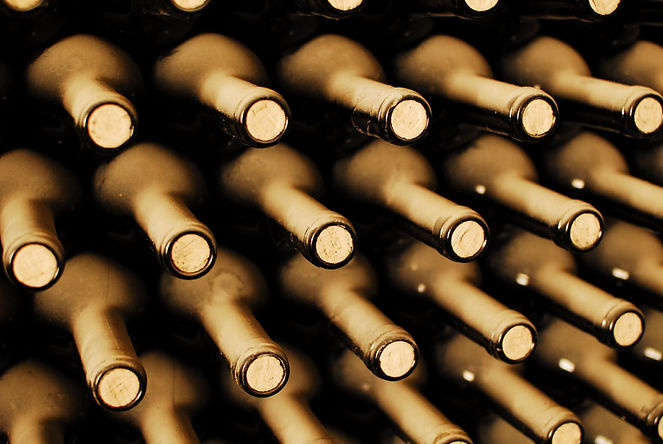 stacked up wine bottles in the cellar, dusty but tasty