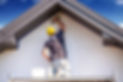 Person painting house exterior