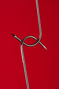 two sharp hooks interlocked together to show how to opposing views can work together