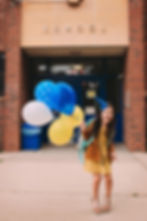 Girl Holding Balloons