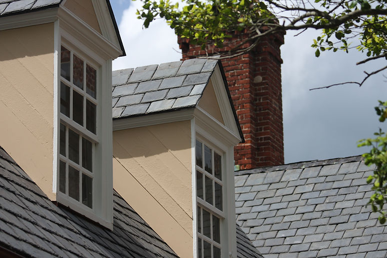 A large house with slate roof tiles