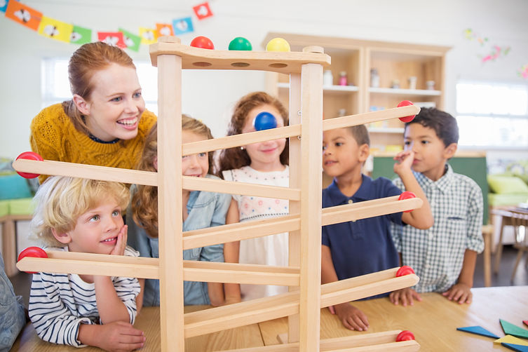 Teacher and children playing together