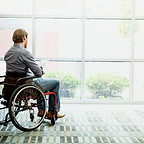 Man on wheelchair with Tablet