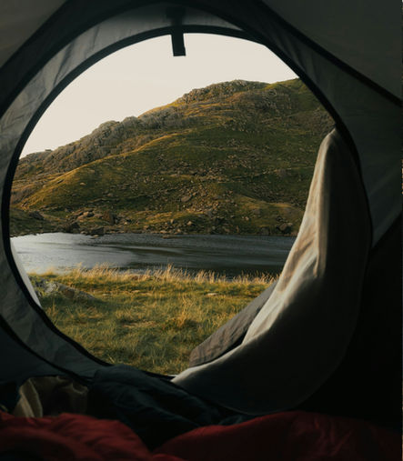 Camping tent near an alpine lake in the mountains