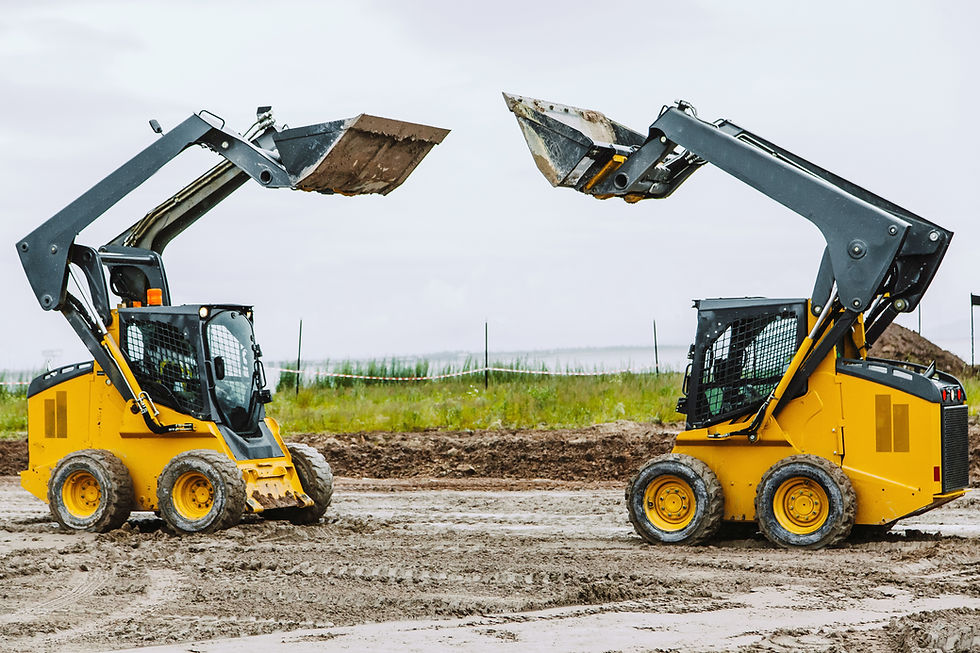 Two yellow and grey bobcat diggers with their buckets raised