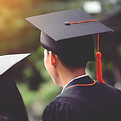 Two people in graduation gowns