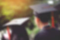Two people in graduation gowns