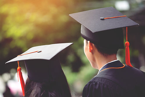 Two people in graduation gowns