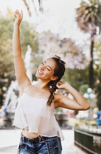 Happy woman with arms raised symbolising confidence and rejuvenation
