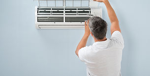 a person opening the front panel of a wall-mounted split air conditioner