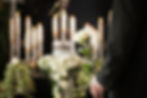 Man with white roses at urn funeral