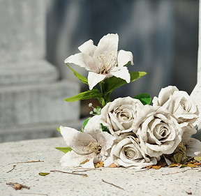 Artificial white flower on grave