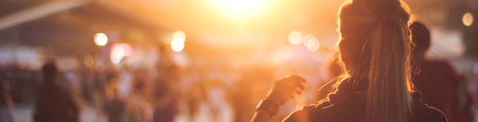 Girl with a pony tail looking to to the sun as it sets.