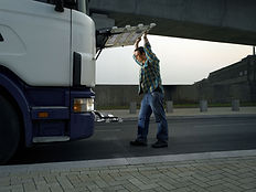 Man examining truck's engine