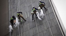 Workers Repairing Outside Of Building
