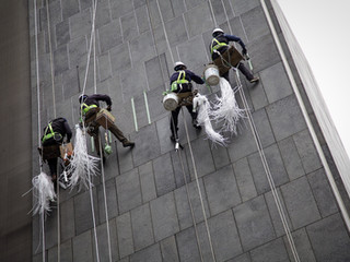 Workers Repairing Outside Of Building